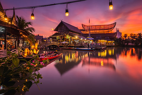 Sunset at Pattaya Floating Market with traditional rowing boats