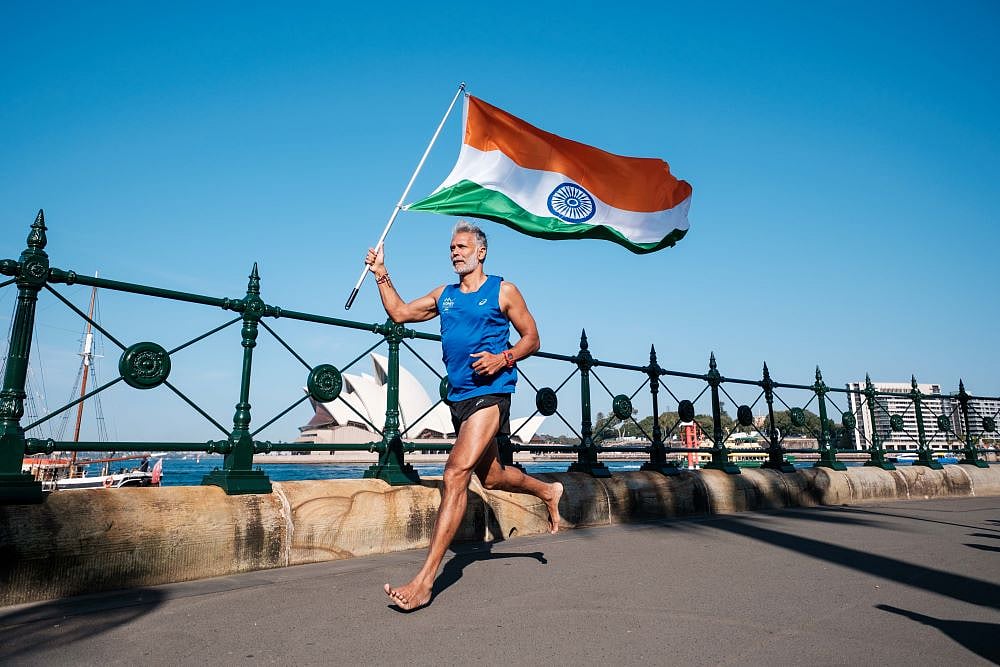 MSL Group : Milind Soman with the Indian flag at Sydney Marathon finish