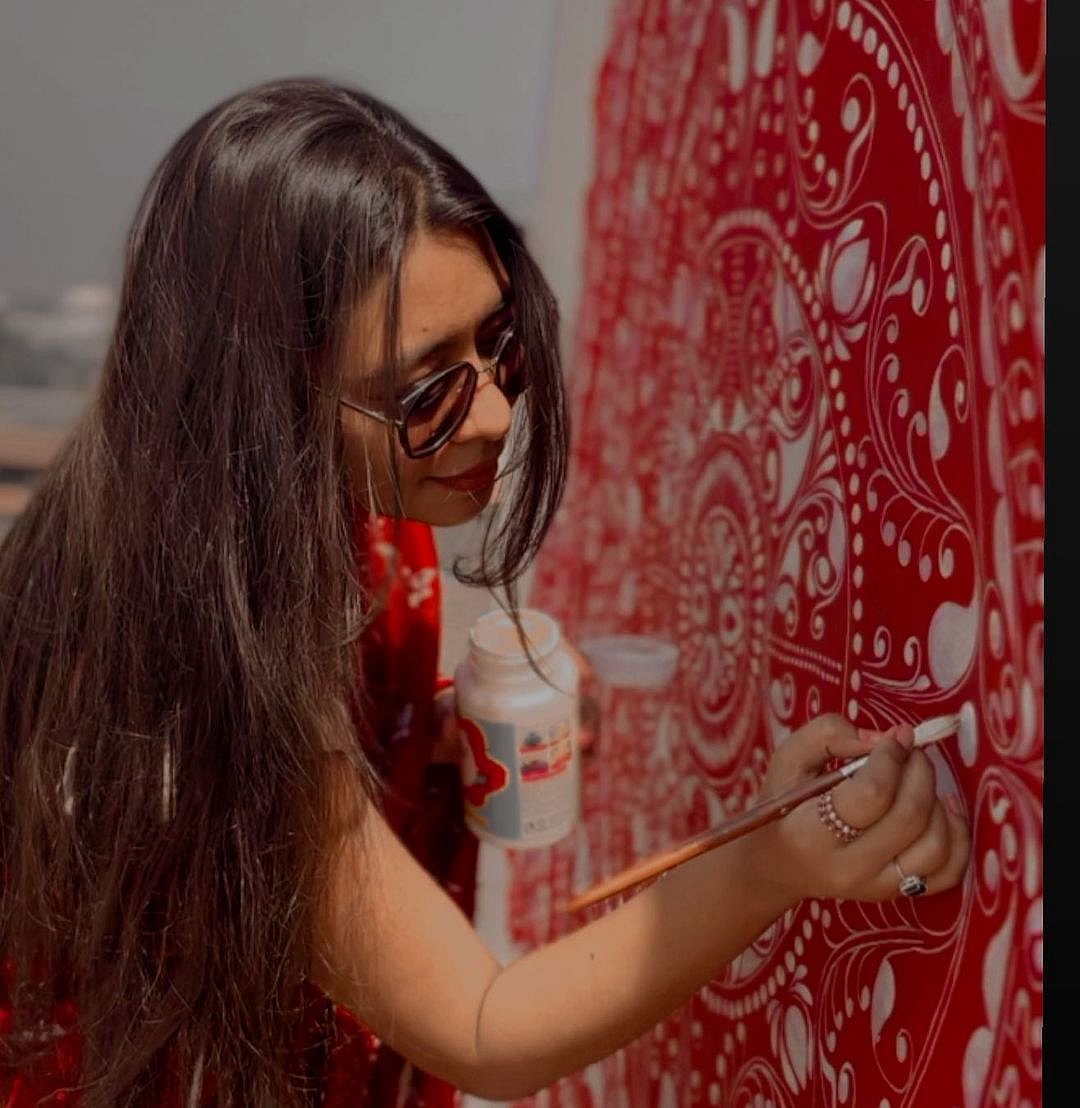 Banerjee at work on an alpona