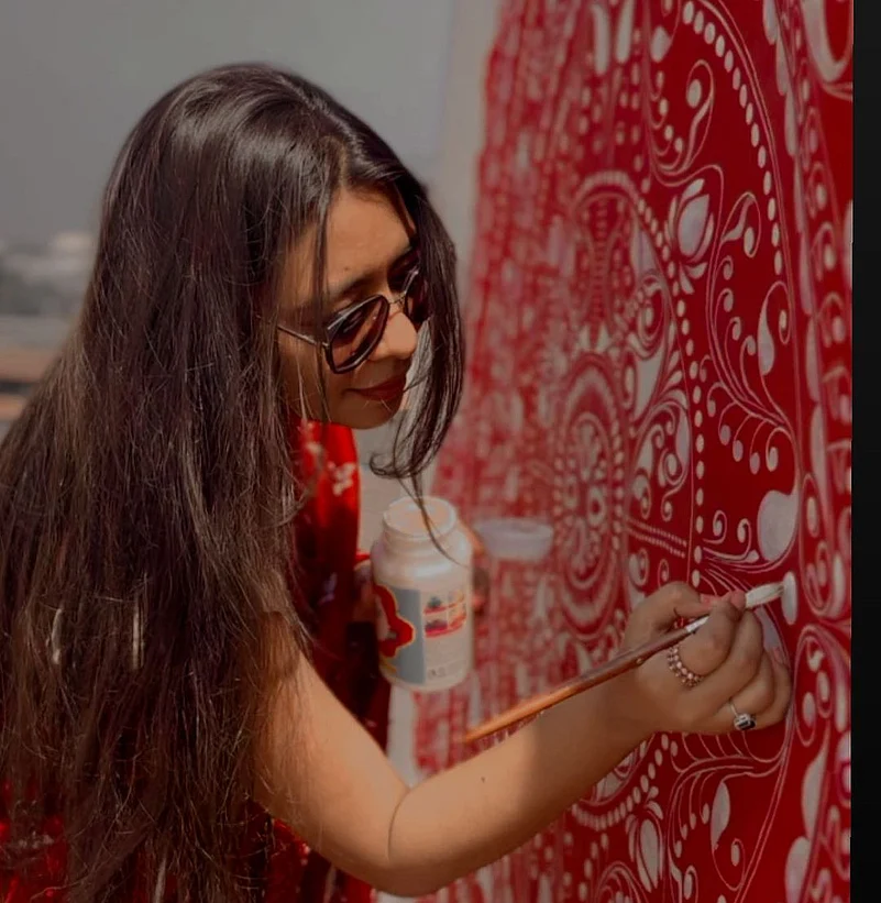 Banerjee at work on an alpona