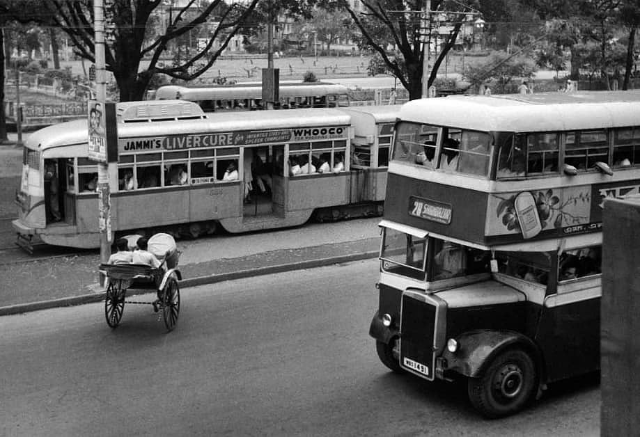 An L class 544, a route 28 double decker bus and a traditional hand pulled rickshaw. Circa 1960s