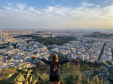 A woman posing against a view