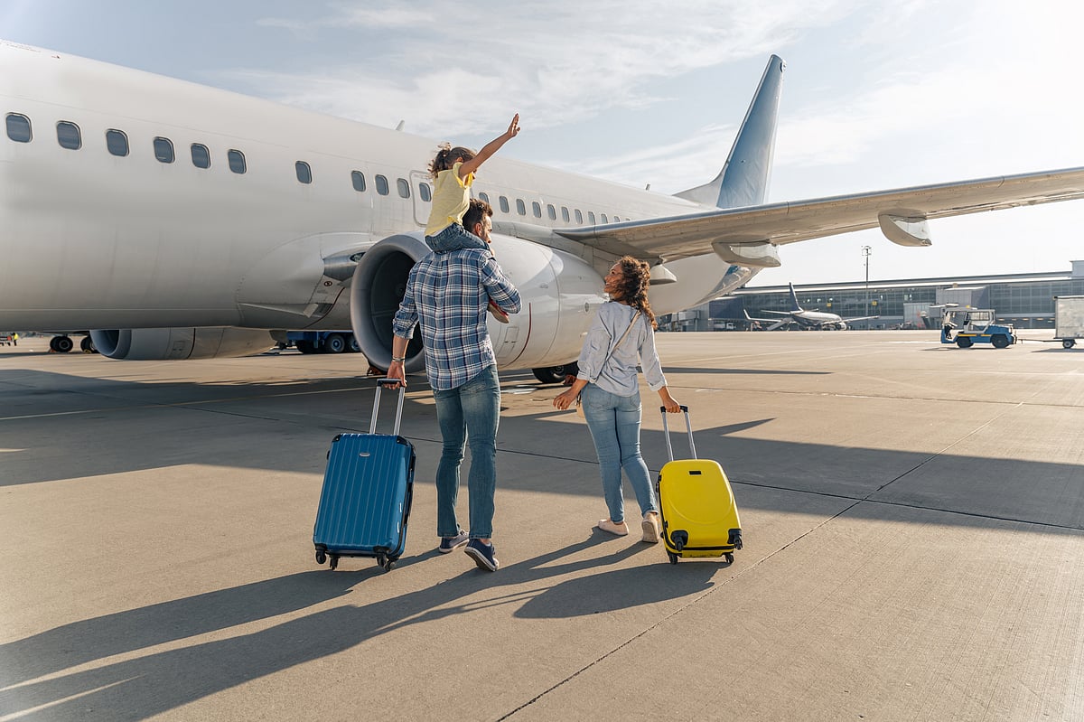 Family standing near a large plane
