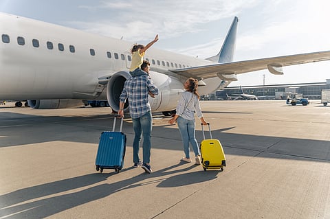 Family standing near a large plane