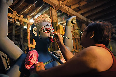 Artist painting eyes of goddess Kali in Kumartuli, Kolkata
