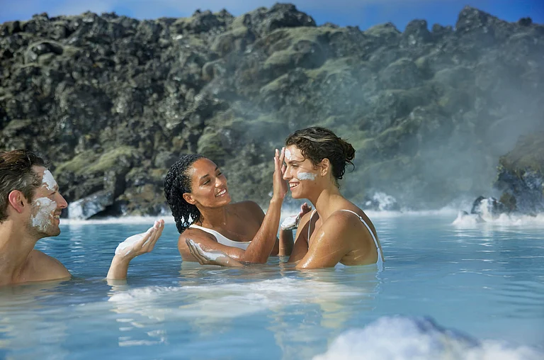 Visitors enjoying a spa session at the Blue Lagoon, Iceland - bluelagoon.com/website