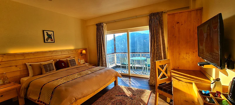 The plush furnishings and wooden structure lend an element of serenity to the rooms