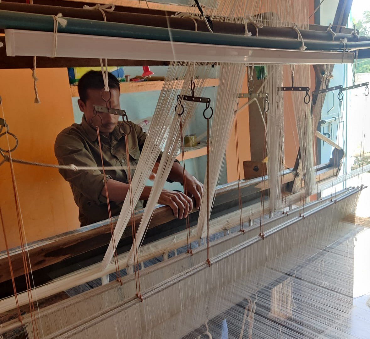 A weaver at work on a handloom in Pranpur