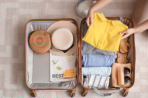 Person packing suitcase