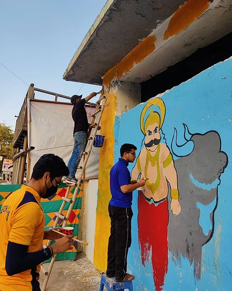 NGO volunteers engaged in mural work 