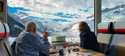 Man Points At Swiss Alps From The Glacier Express