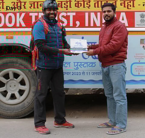 Rency with a member of the National Book Trust team