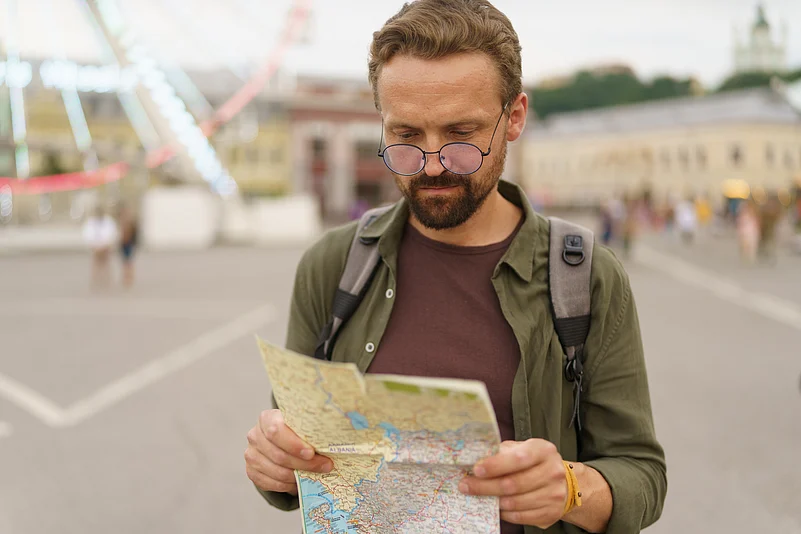 Traveller curiously reading a paper map