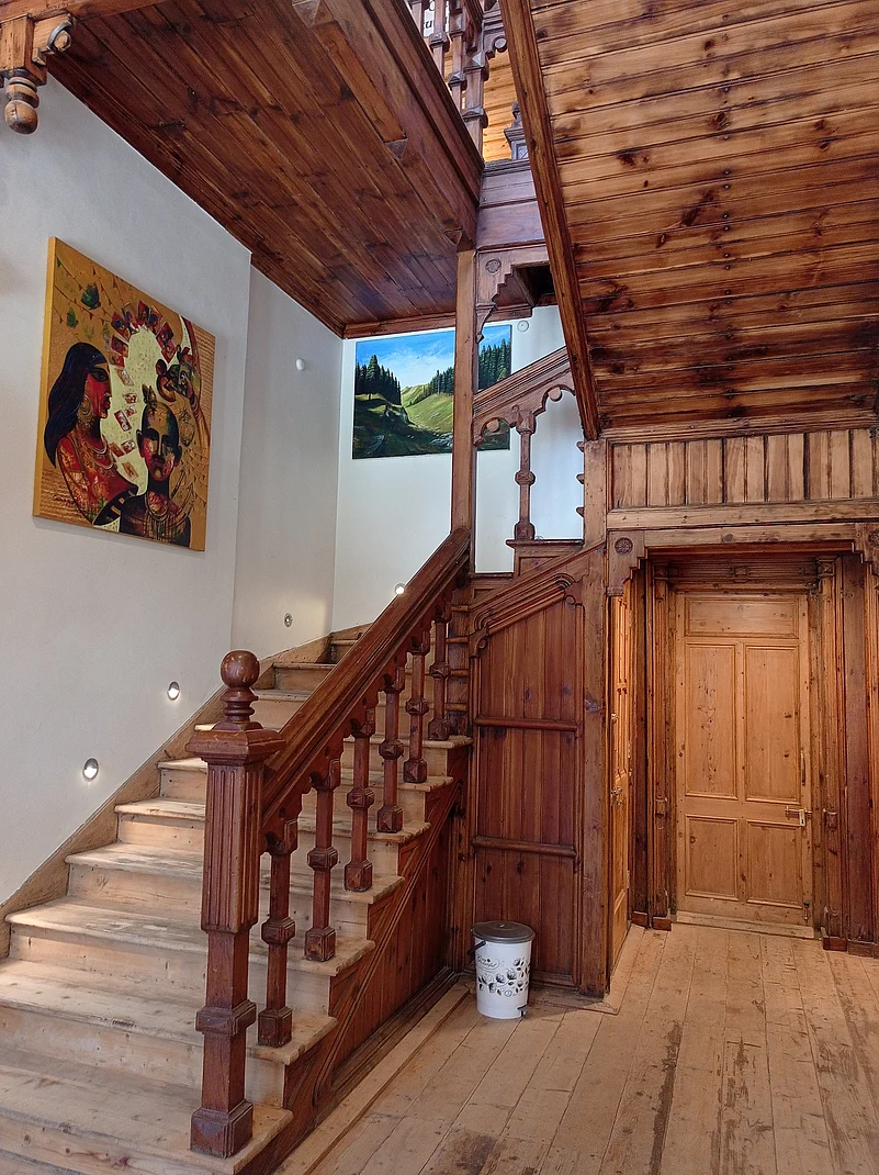 The wooden staircase along with paintings