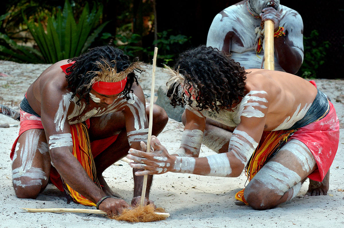 Australian Aboriginals men demonstrating fire making craft during Aboriginal culture show 