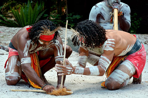 Australian Aboriginals men demonstrating fire making craft during Aboriginal culture show
