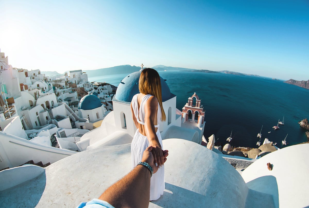 Couple holding hands in Santorini