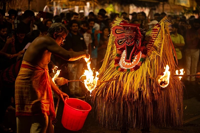 Theyyam artist performing Thee Kuttichathan Theyyam