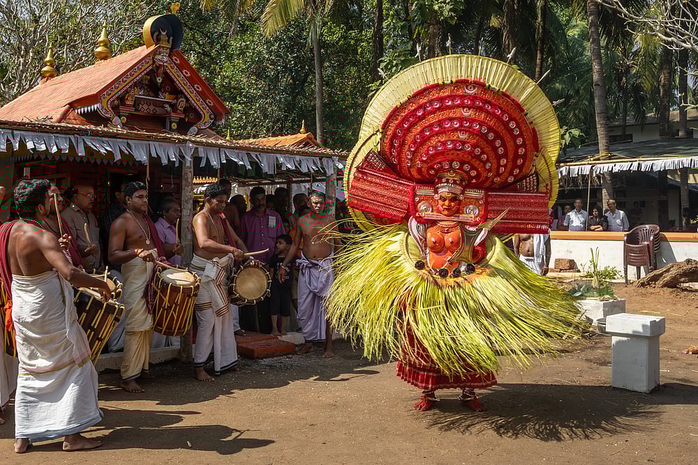 Theyyam artist performs during a temple festival in Payyanur