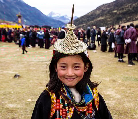 A child in traditional attire at the festival