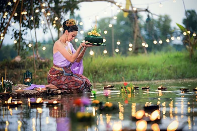 Shutterstock : A Thai woman amidst Loy Krathong celebrations
