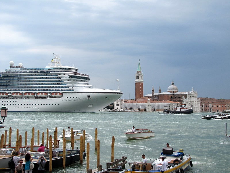 A massive cruise ship dwarfs everything as it enters Venice