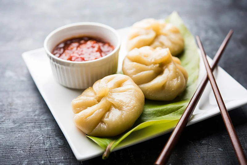 Momos served with traditional red chutney