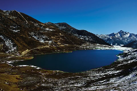 Perched at an altitude of 13,066 feet, Kupup Lake, also known as Elephant Lake, rests serenely amidst majestic peaks. —enroute Jelep La Pass, Sikkim