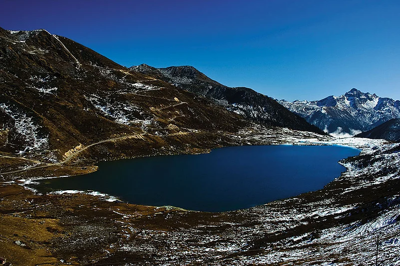Perched at an altitude of 13,066 feet, Kupup Lake, also known as Elephant Lake, rests serenely amidst majestic peaks. —enroute Jelep La Pass, Sikkim