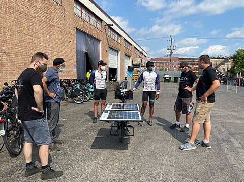 Reddy demonstrating the benefits of solar energy for e-bikes