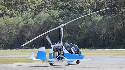 Small blue gyrocopter ready to take off