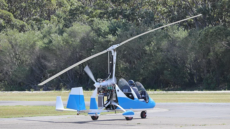 Small blue gyrocopter ready to take off
