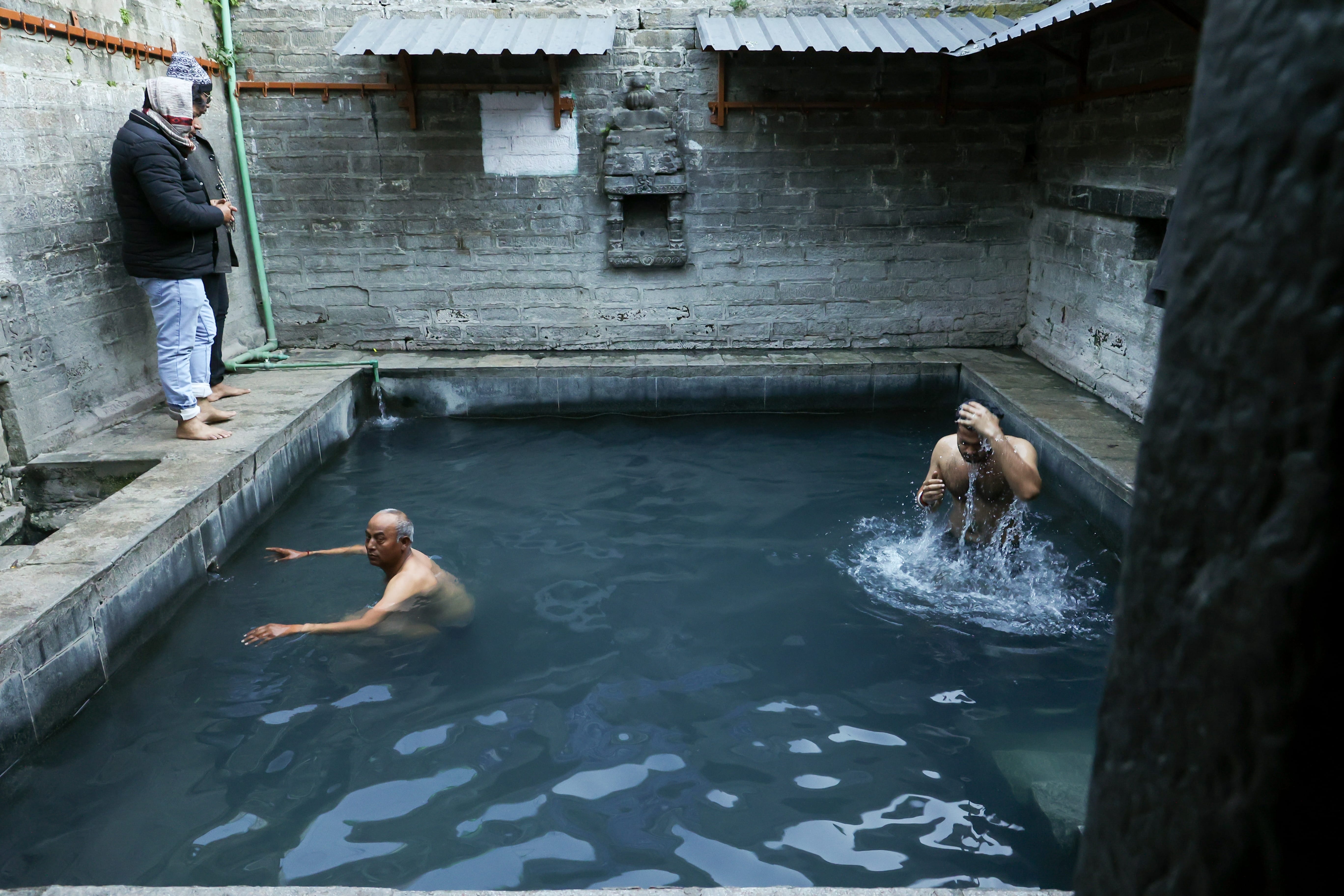 People take a dip in the Vashisht temples hot spring