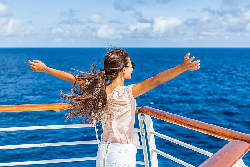 Woman enjoying fresh air on a cruise ship