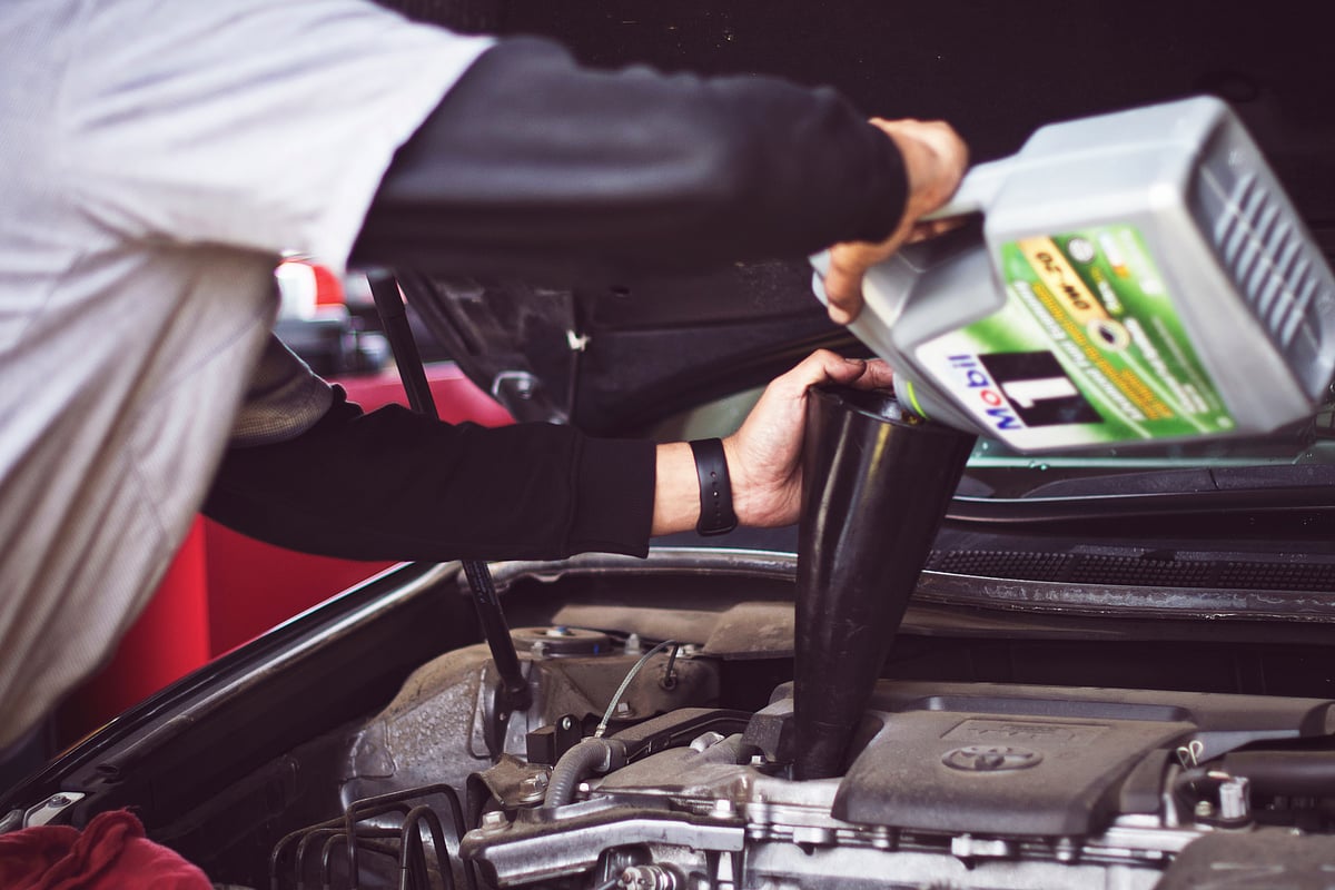 Man oiling a vehicle