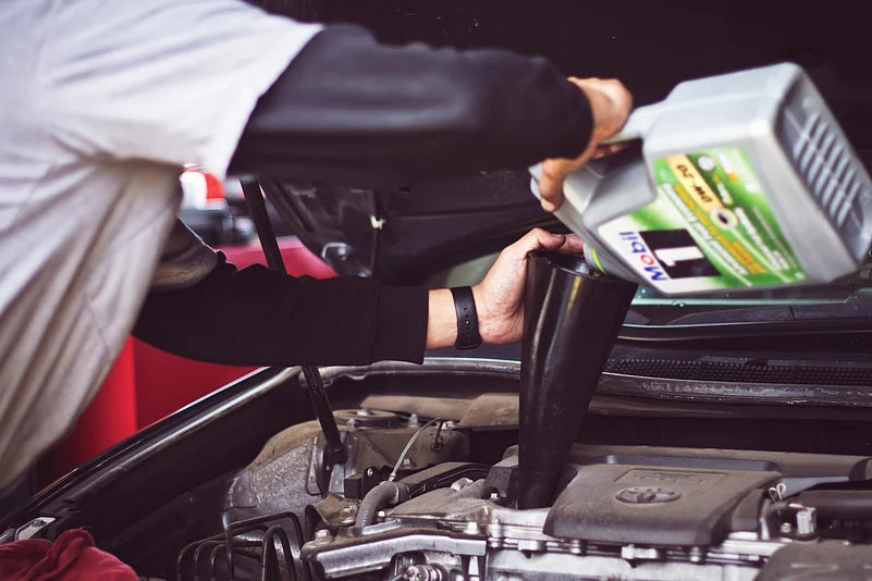 Man oiling a vehicle