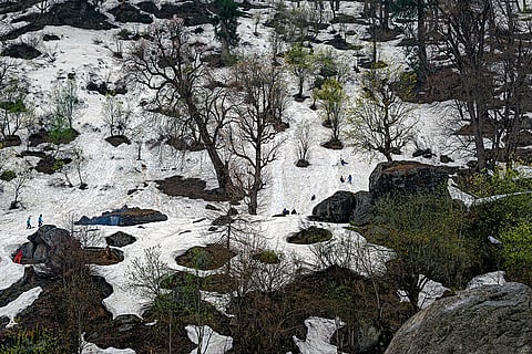 Tourists revel in a winter wonderland, their laughter echoing through the snow-kissed landscapes. —Shimla, Himachal Pradesh