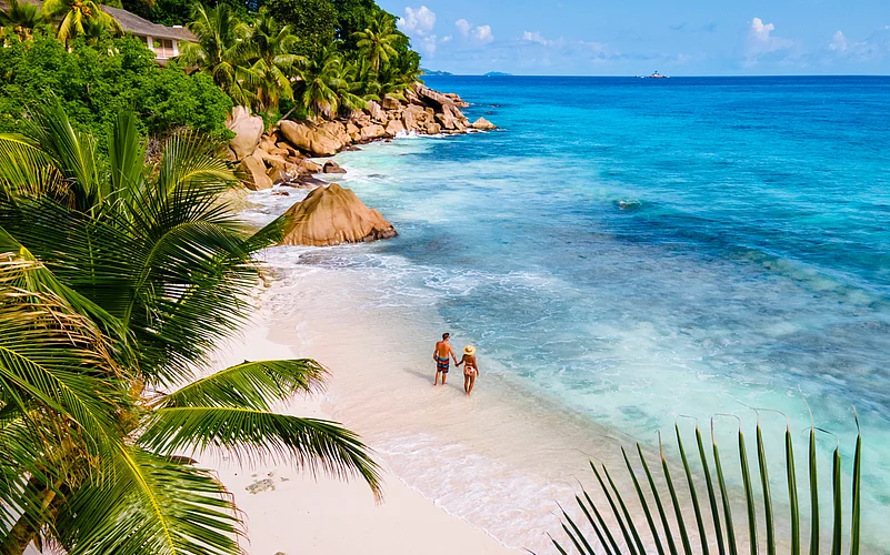 A couple on a tropical beach in Seychelles