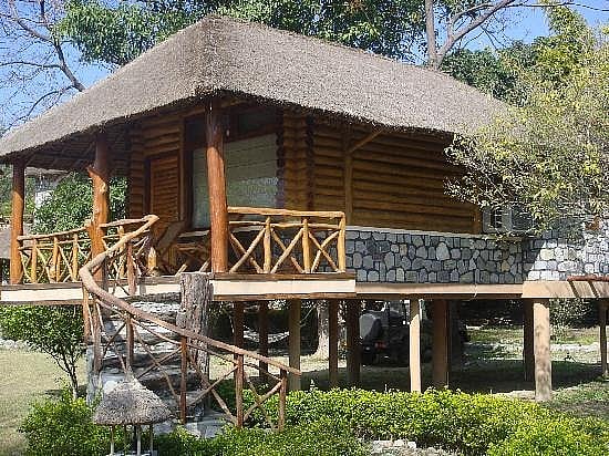 The six plush log huts all overlook the Kosi river