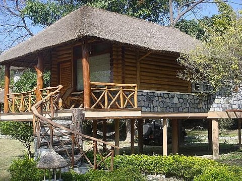 The six plush log huts all overlook the Kosi river