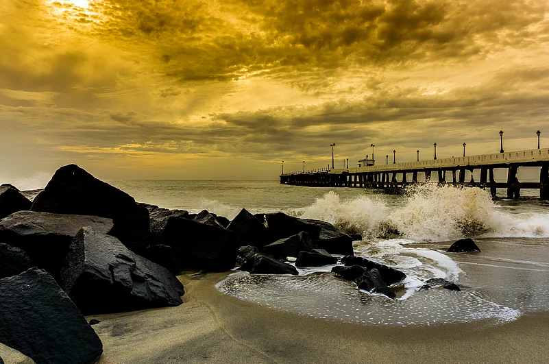The rock beach is a favourite hangout spot for visitors in White Town