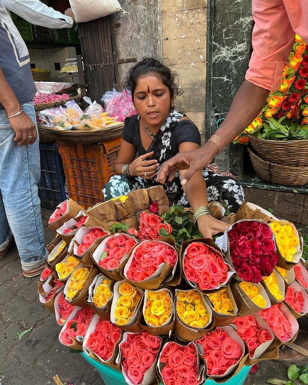 A flower seller does brisk business at the Dadar floower market