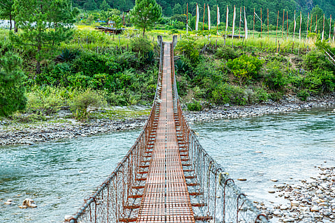 A hanging footbridge connecting a small village to the main road in Punakha. It is the main route for pedestrians and supplies.