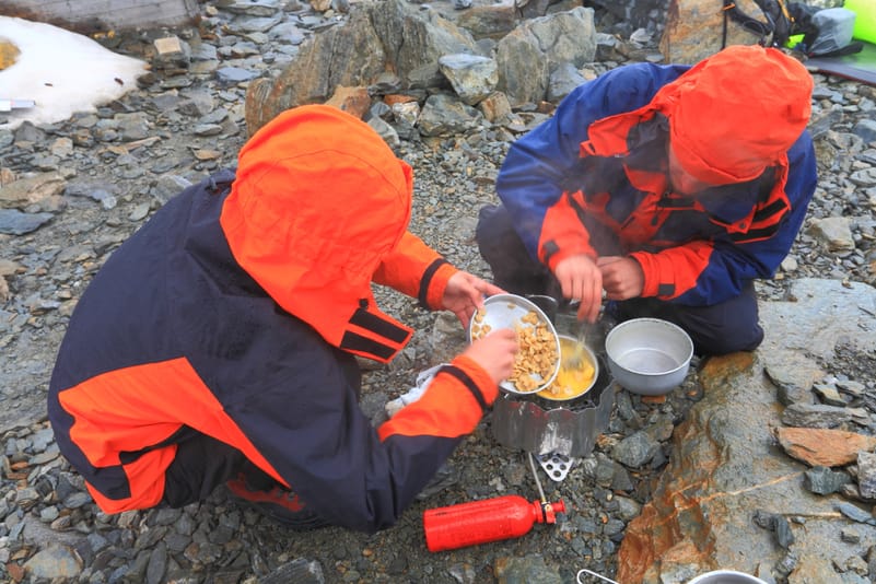 A group of mountaineers cooking