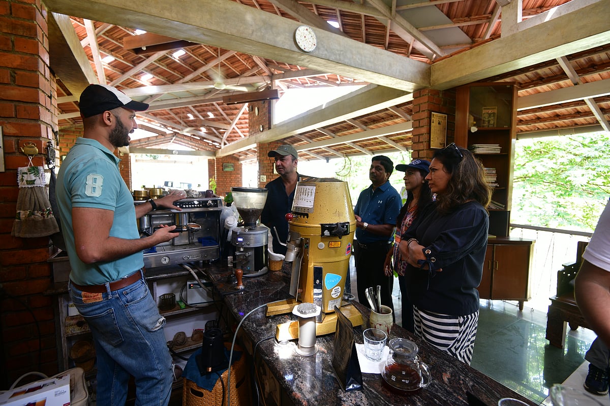 Devaya behind his coffee counter for the coffee sampling session