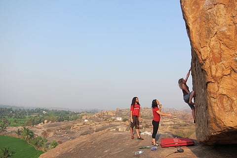 Climbing a boulder in Hampi, Karnataka