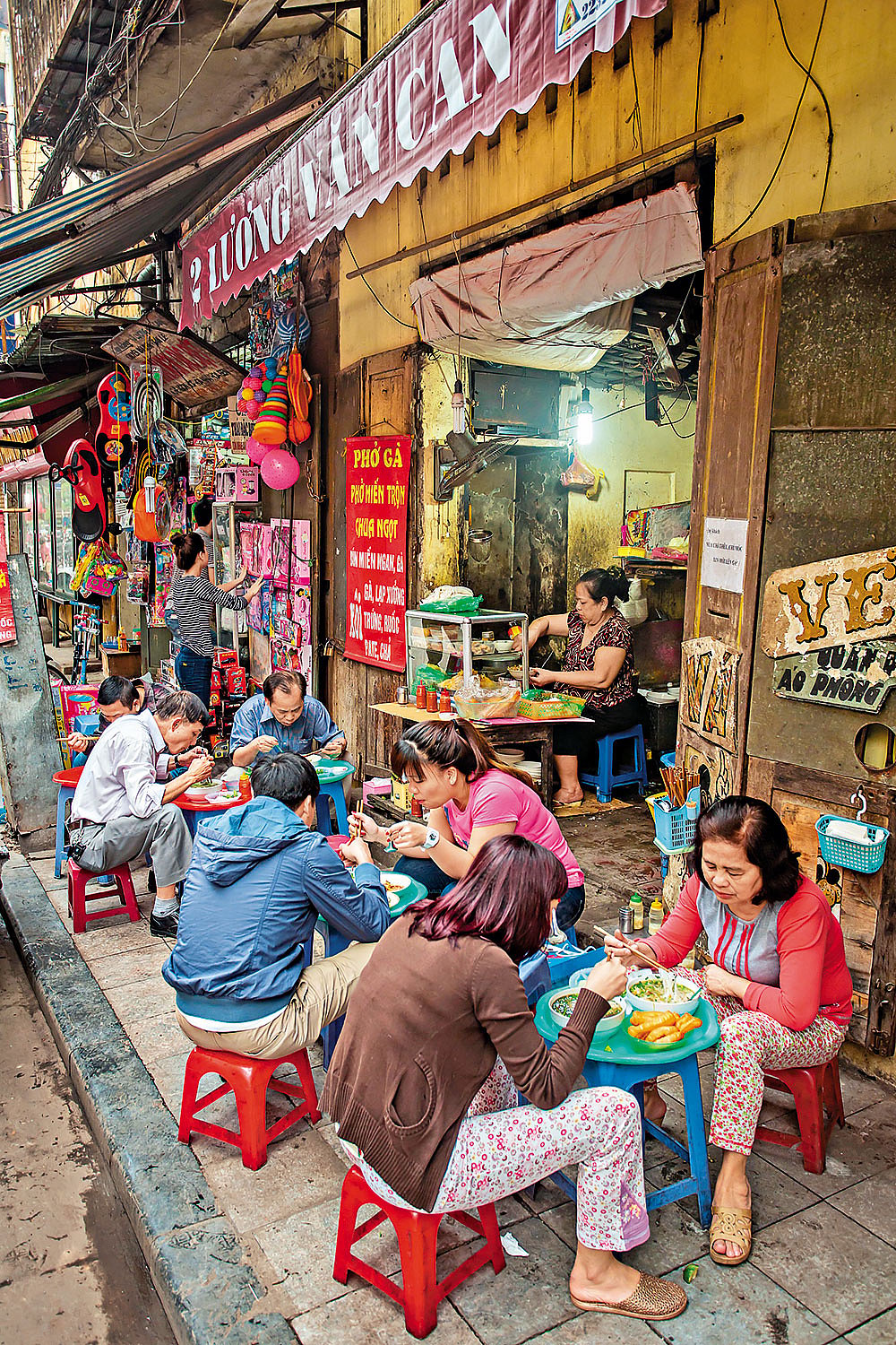 Locals at a streetside pho joint