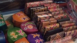 The leather is coloured with vegetable dyes and then handpainted with its signature motifs drawn from nature