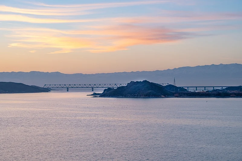 Stunning sunrise on the bay of the Kapchagai reservoir from the Kapchagaisoy hydroelectric power station.