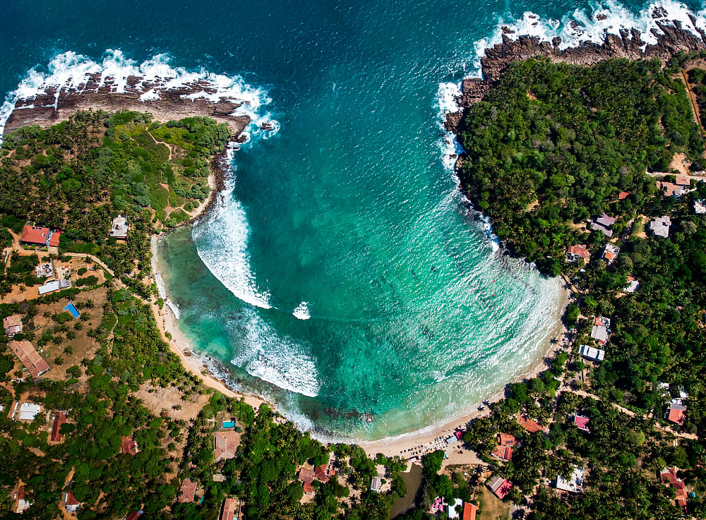The horseshoe-shaped beach is a hub of surfing schools and cafes